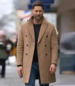 Close-up shot of the tan, double-breasted My Secret Santa wool coat, the same as Ryan Eggold's film coat.