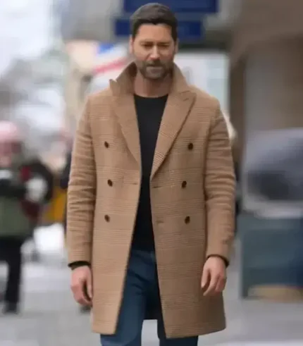 Close-up shot of the tan, double-breasted My Secret Santa wool coat, the same as Ryan Eggold's film coat.