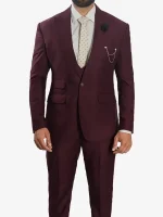 A man wearing a Mens Peak Lapel 3 Piece Burgundy Suit with a matching jacket, vest, and tailored trousers.