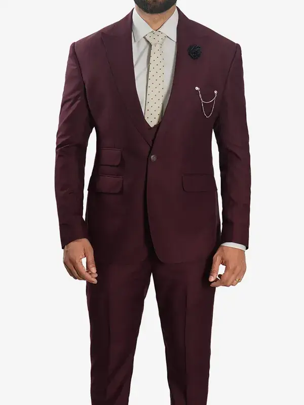 A man wearing a Mens Peak Lapel 3 Piece Burgundy Suit with a matching jacket, vest, and tailored trousers.