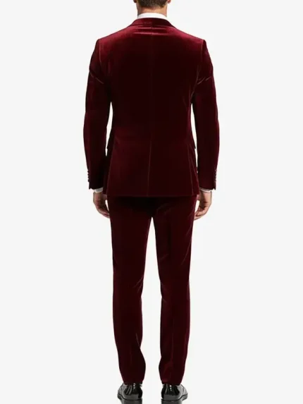 A man wearing a sharp Mens 2 Piece Maroon Velvet Tuxedo with black satin-style lapels and a slim-fit design.