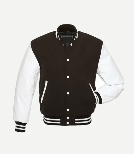 A three-quarter front view of the Brown Varsity Jacket. The angle highlights the texture of the white leather sleeves and the structured fit of the dark brown torso. It features a classic ribbed stand-up collar and matching striped detailing on the waistband and sleeve cuffs.