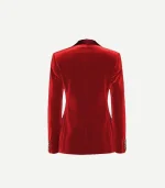 The back view of a women’s tailored red cotton velvet blazer. The image highlights the structured shoulders, a clean center seam for a fitted silhouette, and four small gold buttons on each cuff. The rich, reflective texture of the velvet is prominent against a plain white background.