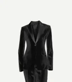 A close-up studio shot of a women's black cotton velvet tuxedo blazer. The image highlights the contrasting satin peak lapels, a single button at the waist, and two jetted pockets. The plush, matte texture of the velvet provides a high-contrast look against the glossy lapels.