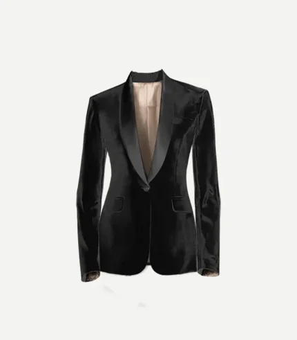 A close-up shot of the black velvet tuxedo jacket with a satin shawl lapel. The jacket is shown open, revealing a light-colored interior lining, and includes jetted side pockets and a standard breast pocket.