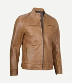 A side-angle view of a camel brown leather jacket, highlighting the tailored fit, zippered sleeve cuffs, and the textured grain of the leather under bright lighting.