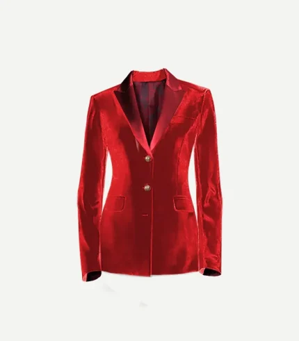 A close-up front view of a women's red cotton velvet tuxedo jacket. The jacket features contrasting satin peak lapels, a single chest welt pocket, and two flap pockets at the hips. Two ornate gold buttons are visible at the center closure, and the dark patterned interior lining is slightly visible at the neck.