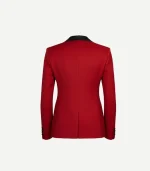 A back view of a women's tailored red velvet blazer against a plain white background. The jacket features a structured fit with a center back seam and a single vent at the hem. The top of the black satin collar is visible, and four small black buttons line each cuff.