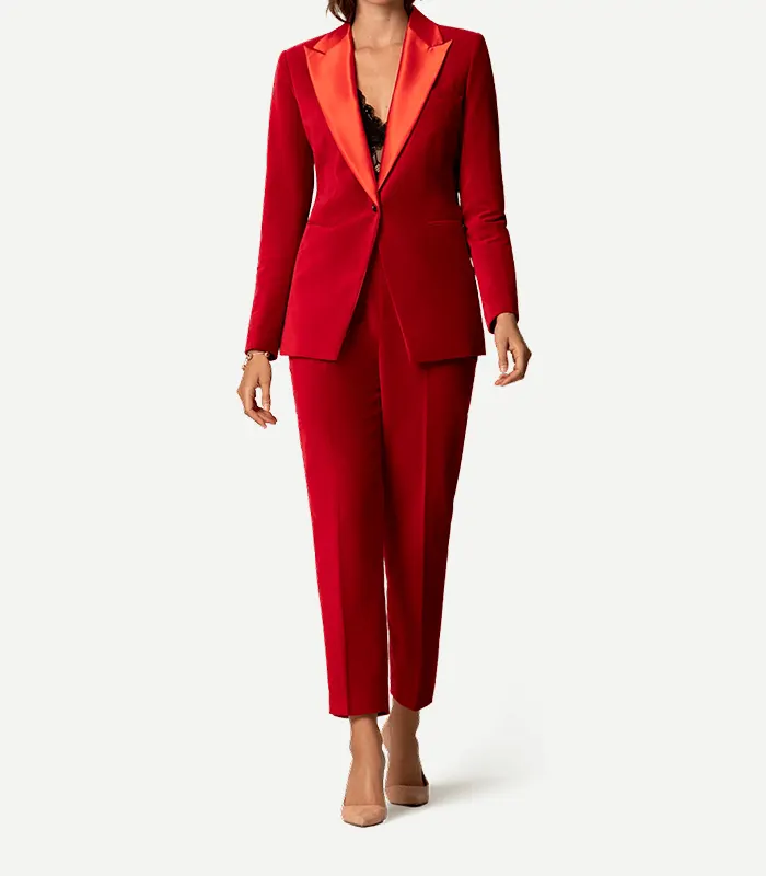 Womens Red Velvet Tuxedo With Red Lapel A full-length view of a model walking in Womens Red Velvet Tuxedo With Red Lapel. She is wearing a black lace top underneath and nude-colored heels.