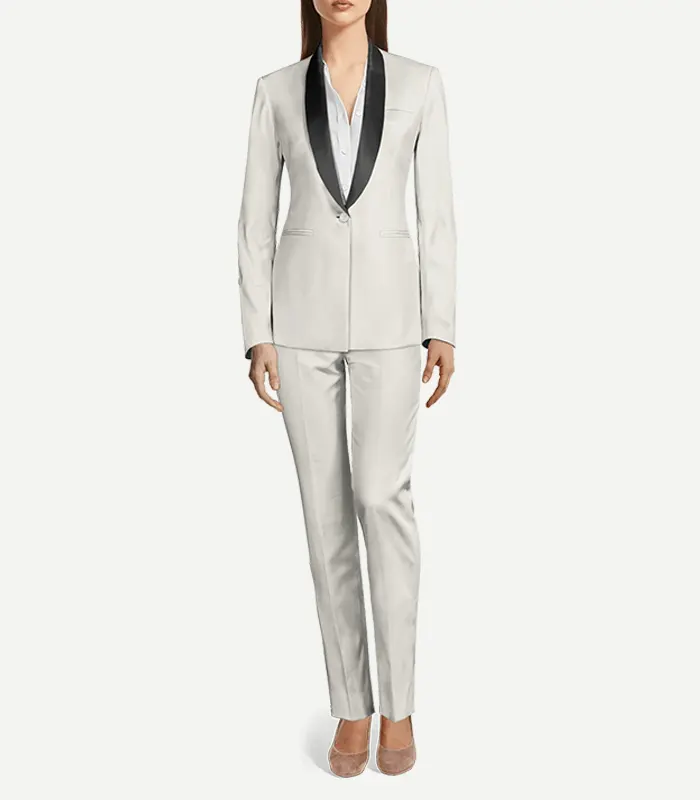 Womens White Wool Tuxedo A full-body view of a woman wearing a tailored white wool tuxedo with contrasting black shawl lapels. The slim-fit blazer features a single-button closure over a white collared shirt, paired with matching white slim-leg trousers and neutral pointed-toe flats.