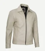 Side-angled view of a neutral beige leather jacket highlighting the smooth grain texture, silver hardware, vertical stitching, and comfortable, stylish fit.
