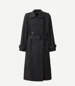 A full-length studio product shot of the black cotton trench coat against a plain white background. This clear view highlights the double-breasted design with six visible dark buttons, a matching belt with a rectangular buckle, buckled sleeve straps, and traditional shoulder epaulets.