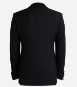 Rear view of a black dinner jacket showing a clean, structured silhouette with a central seam, smooth shoulders, and four-button detailing on the sleeve cuffs.