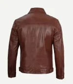 Back view of a brown leather jacket showing the detailed stitching across the shoulders and the adjustable button straps at the hem.