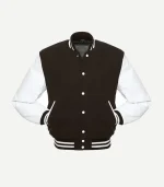 A straight-on front view of a men's varsity jacket featuring a dark brown wool body and contrasting white leather sleeves. The jacket has white snap-button fasteners down the center and two front pockets with white leather welts. The collar, cuffs, and hem are made of ribbed brown fabric with two white horizontal stripes.