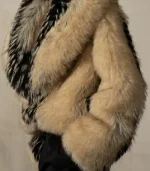 A side-angle view of the large, shaggy fur coat. The image shows the heavy volume of the sleeves and the way the black-and-white patterned fur wraps around the shoulders and back.