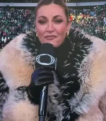 Another angle of Erin Andrews on the sidelines, showing the full texture of the fur coat. The black and white "frosted" tips of the fur on the collar stand out against the stadium background filled with fans in green.