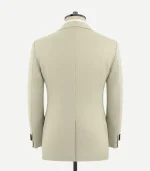 Back view of a light beige wool tuxedo jacket on a mannequin. The image shows a clean, tailored fit with a single center vent at the hem and four black buttons on each sleeve cuff.