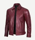 Front view of a men’s maroon leather jacket shown from a slight angle, featuring a black lining, silver zipper, and classic pointed collar.