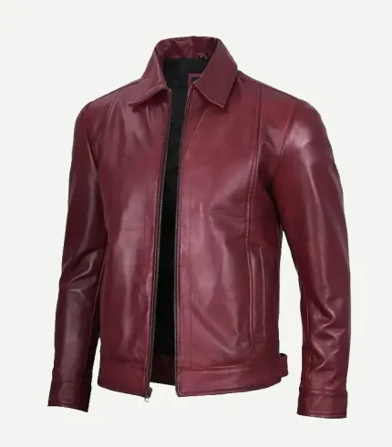 Front view of a men’s maroon leather jacket shown from a slight angle, featuring a black lining, silver zipper, and classic pointed collar.