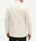 A rear view of a man wearing a white wool dinner jacket with a single center vent. The jacket has a regular fit through the torso and sleeves, with four buttons visible on the cuffs, paired with black formal trousers.