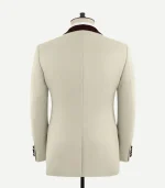 Rear view of the Stretch Beige Wool Tuxedo Jacket showing the tailored fit, center vent, and burgundy velvet collar detail.