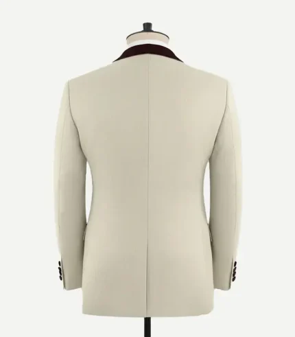 Rear view of the Stretch Beige Wool Tuxedo Jacket showing the tailored fit, center vent, and burgundy velvet collar detail.