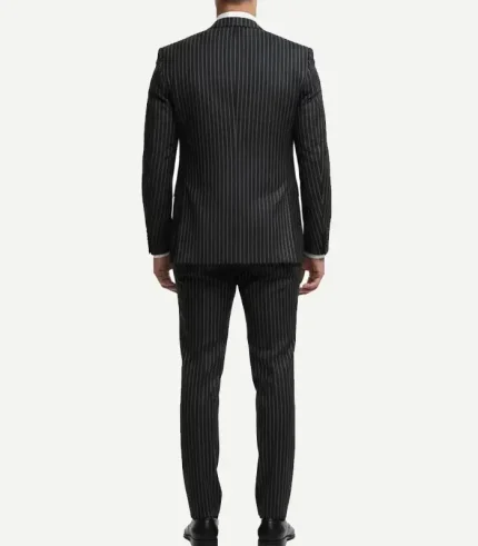 Rear view of a man wearing a black or dark grey pinstripe suit jacket and matching trousers against a plain white background.