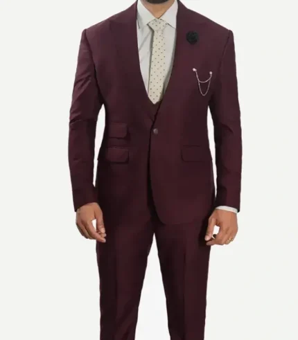 A front view product shot of a male model wearing a sharp, slim-fit burgundy three-piece suit featuring wide peak lapels, a double-breasted vest, a white dress shirt, and a black bowtie.