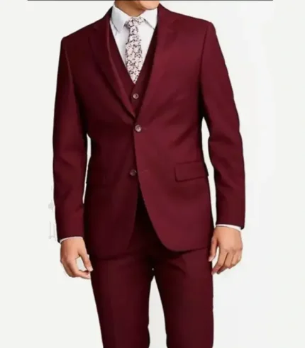 A front view product shot of a man wearing a slim-fit maroon three-piece suit, featuring a tailored two-button jacket, a matching vest, a white dress shirt, and a white floral pattern necktie.