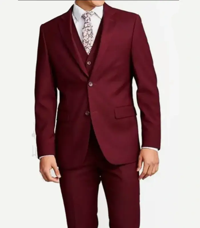 A front view product shot of a man wearing a slim-fit maroon three-piece suit, featuring a tailored two-button jacket, a matching vest, a white dress shirt, and a white floral pattern necktie.