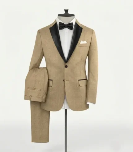 Studio display of the men's spring latte tortilla brown tuxedo suit on a mannequin, highlighting the black satin shawl lapel collar and folded matching trousers.